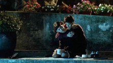 a teenage Taiwanese boy and girl drink coffee in a garden at night